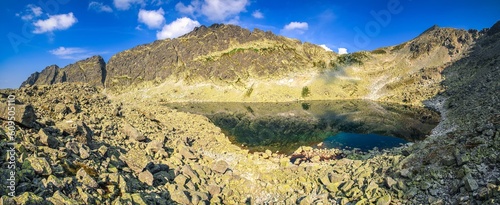 Panorama with summer mountain landscape. Lake in High Tatra Mountains, Slovakia.
