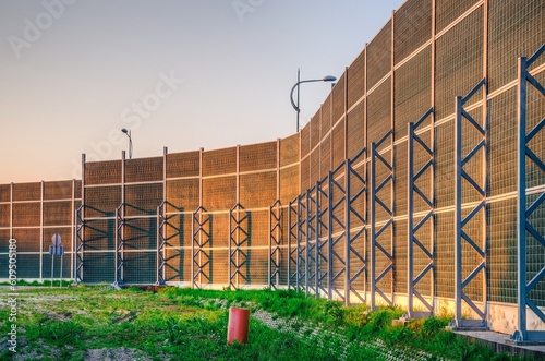 Soundproof wall by the roadside. Soundproofing wall of the high-speed road.
