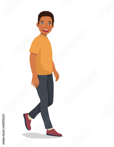 Handsome young African man walking forward with smiling expression