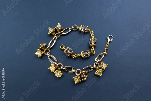 Beautiful gold chain bracelet with flower bud charms, unique handmade jewelry background, rhinestone jewelry concept, promotional photo for an online jewellery store © Elena