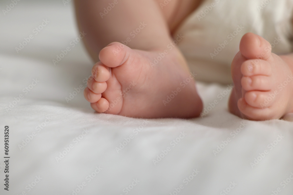 Cute little baby in diaper on bed, closeup Cute little baby in diaper on bed, closeup