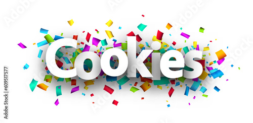 Cookies sign over cut out ribbon confetti background.