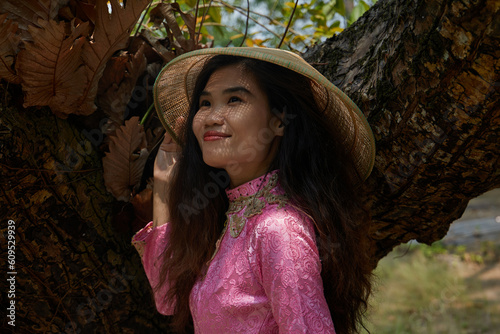Vietnamese woman in traditional clothes in the countryside in Vietnam.