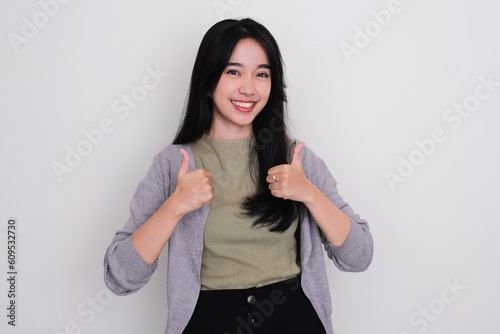 Young Asian women smiling happy and give two thumbs up photo