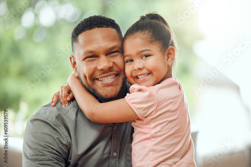 Family, father hug daughter and smile in portrait with bonding, love and care, happiness at home. Happy man with young girl and affection in relationship, people relax together with bond and trust