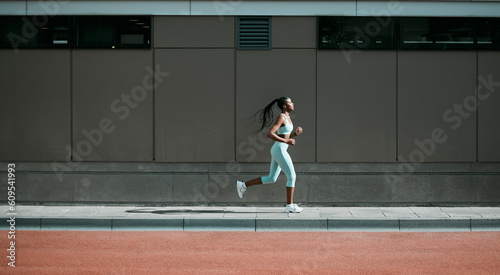 Fotografia Black woman, running and city sport on sidewalk with training, exercise and fitness on road