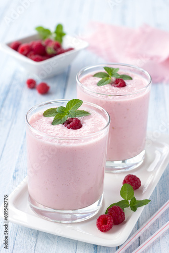 milkshake with fresh raspberries in a glass