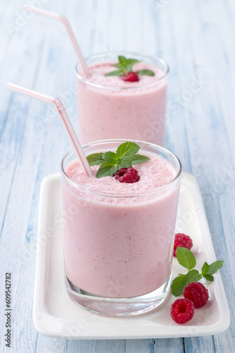 milkshake with fresh raspberries in a glass