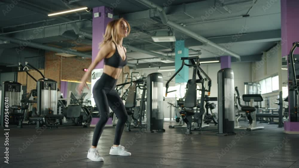 athletic young woman in black sportswear doing aerobic exercise in gym. slow motion. High quality 4k footage