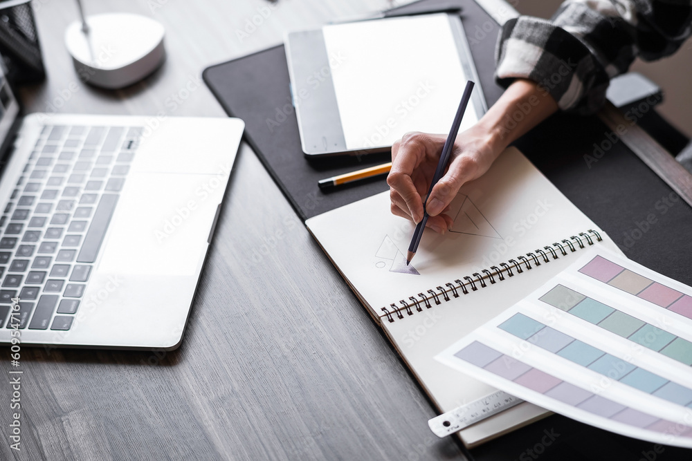 Graphic designer working with sketching logo design at office. Graphic designer working with sketching logo design at office.