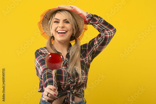 Beautiful brazilian woman, with festa junina clothes, on yellow background