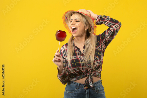 Beautiful brazilian woman, with festa junina clothes, on yellow background