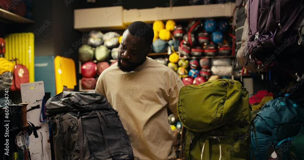 Decoding Adventure: An Afroamerican's Dual Backpack Dilemma in a Specialized Gear Store