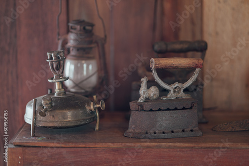 Antique coffee grinder with a rusty iron handle isolated on white photo