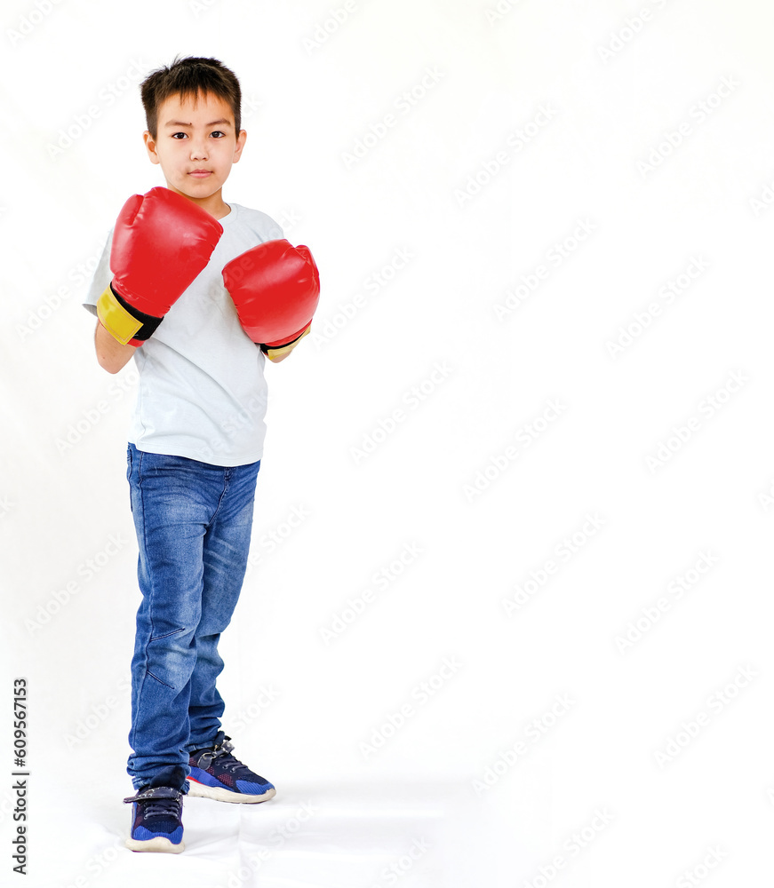 Portrait of an active boy, a novice boxer in sports gloves, highlighted on a white background. The concept of sports, movement, study, achievements, lifestyle. A place to copy ads Portrait of an active boy, a novice boxer in sports gloves, highlighted on a white background. The concept of sports, movement, study, achievements, lifestyle. A place to copy ads