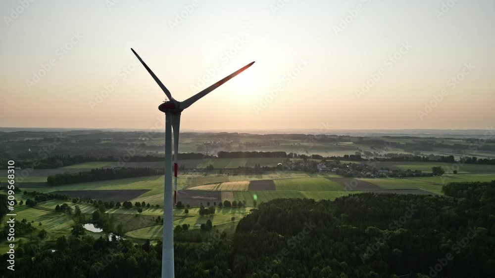Wind turbine seen from an aerial view turning slowly in the early morning sunrise Wind turbine seen from an aerial view turning slowly in the early morning sunrise