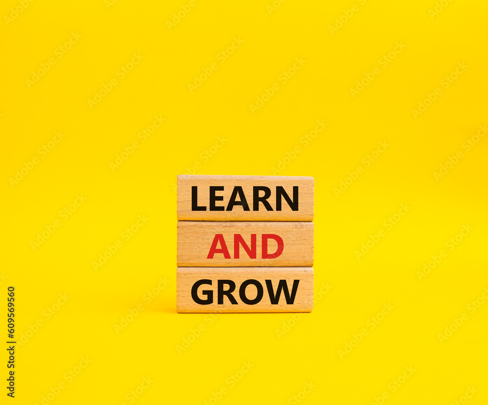 Learn and grow symbol. Concept words Learn and grow on wooden blocks. Beautiful yellow background. Business and Learn and grow concept. Copy space. Learn and grow symbol. Concept words Learn and grow on wooden blocks. Beautiful yellow background. Business and Learn and grow concept. Copy space.