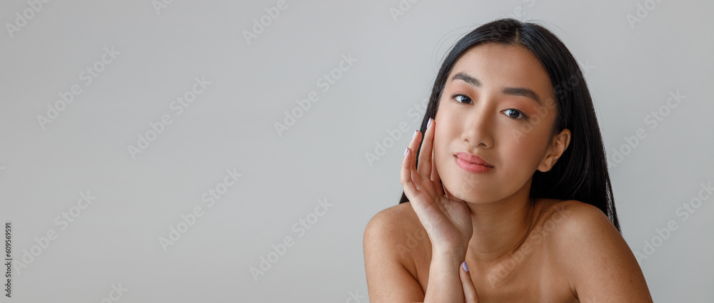 Obraz premium Young woman touching her face with perfect skin