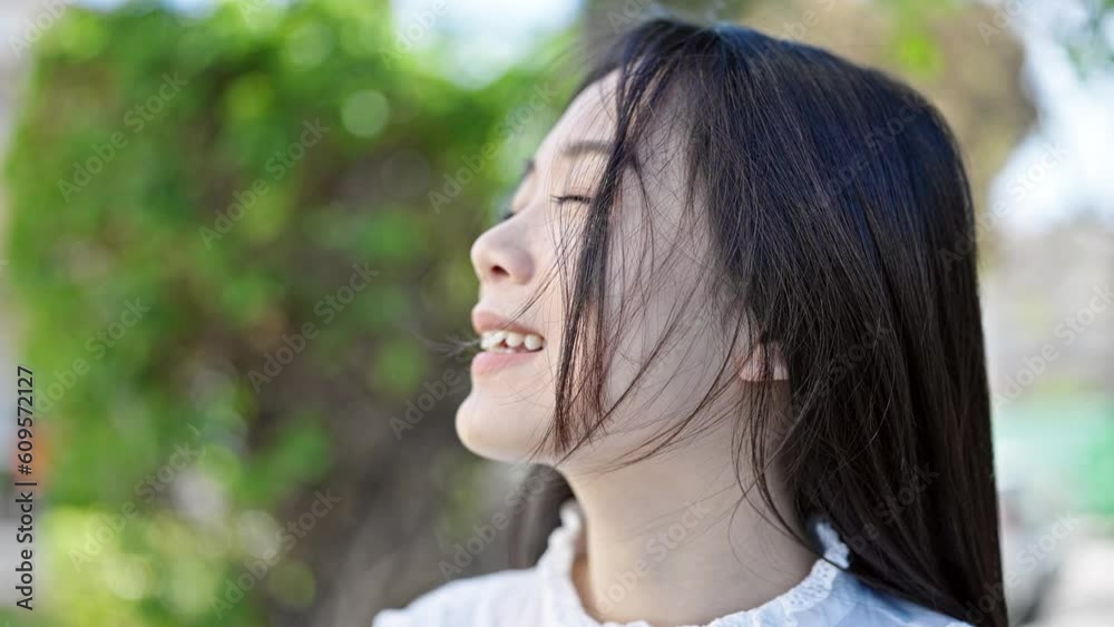 Young chinese woman breathing with closed eyes at park Young chinese woman breathing with closed eyes at park