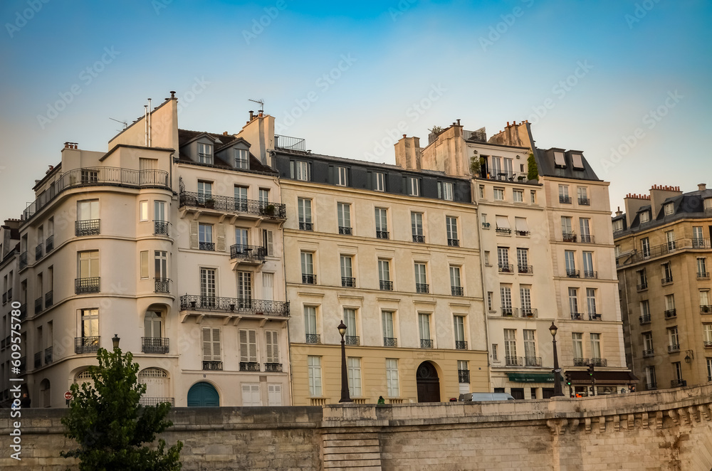 Exterior view of an aged gray residential building located in Paris.