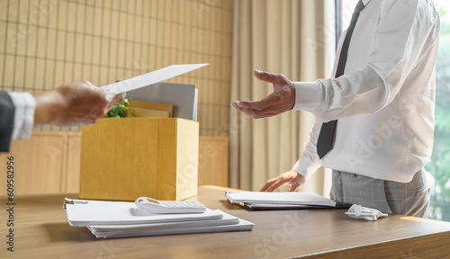 Quit Job Business man sending resignation letter and packing Stuff Resign Depress or carrying business cardboard box in office. Change of job or fired from company.