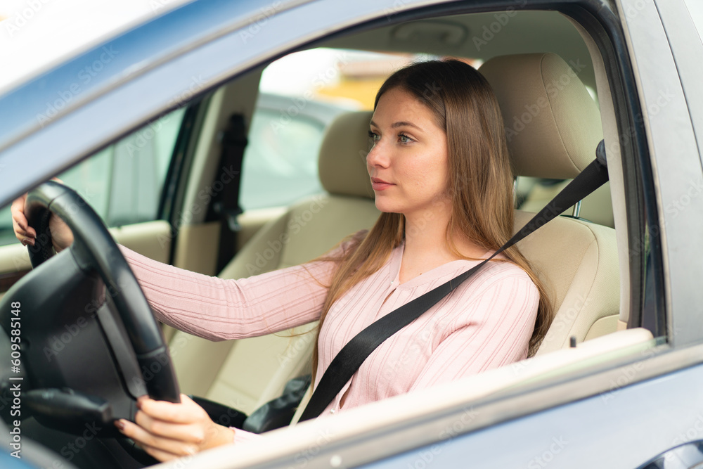 Young pretty blonde woman inside a car