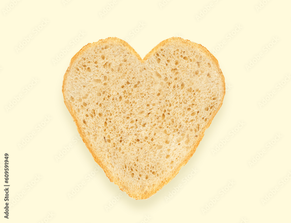 Abstract creative heart shaped cut-out from slice of white bread on light yellow background. Minimal flat lay. love food concept Abstract creative heart shaped cut-out from slice of white bread on light yellow background. Minimal flat lay. love food concept