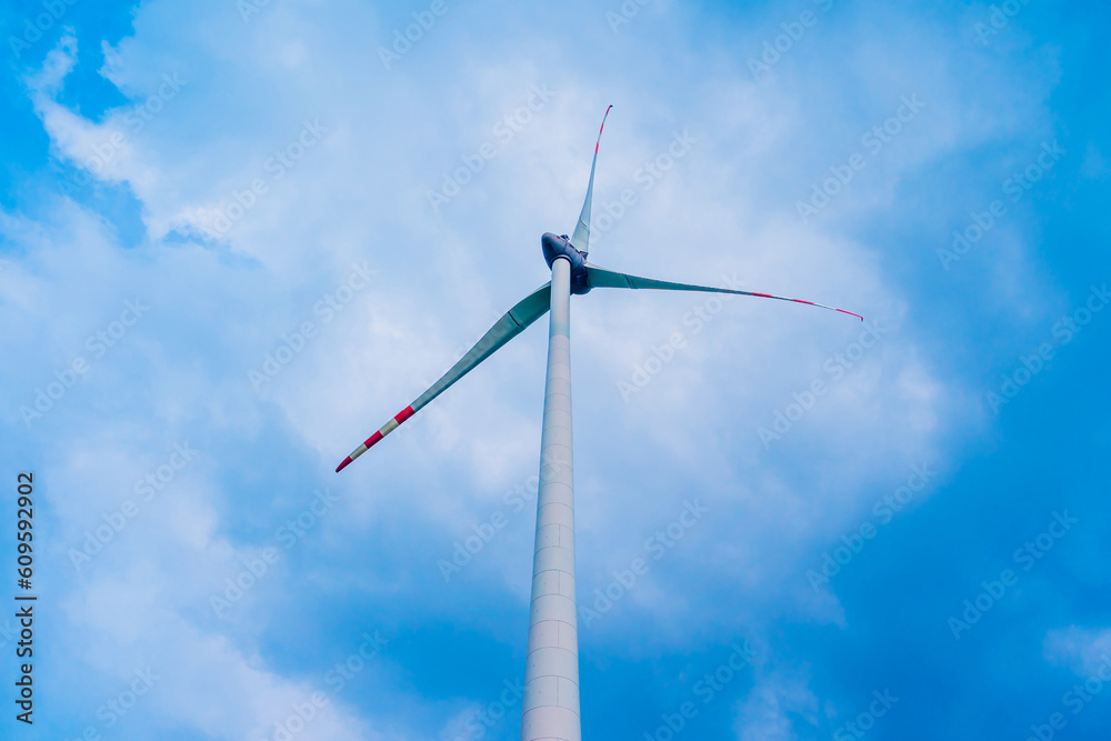 Windmill farm at the fields with beautiful blue sky Windmill farm at the fields with beautiful blue sky