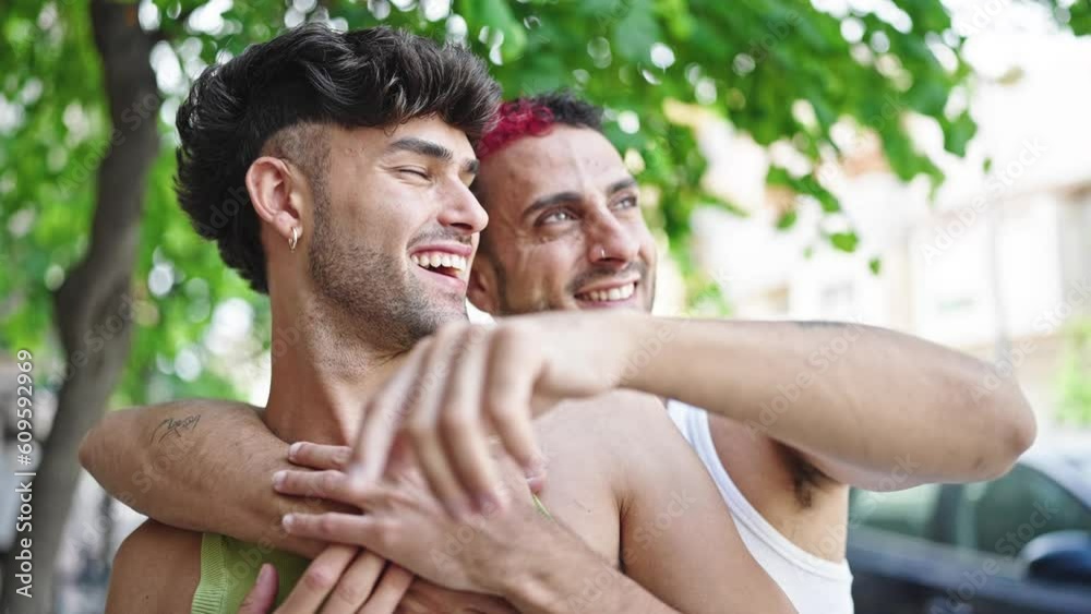 Two men couple smiling confident hugging each other at park Two men couple smiling confident hugging each other at park