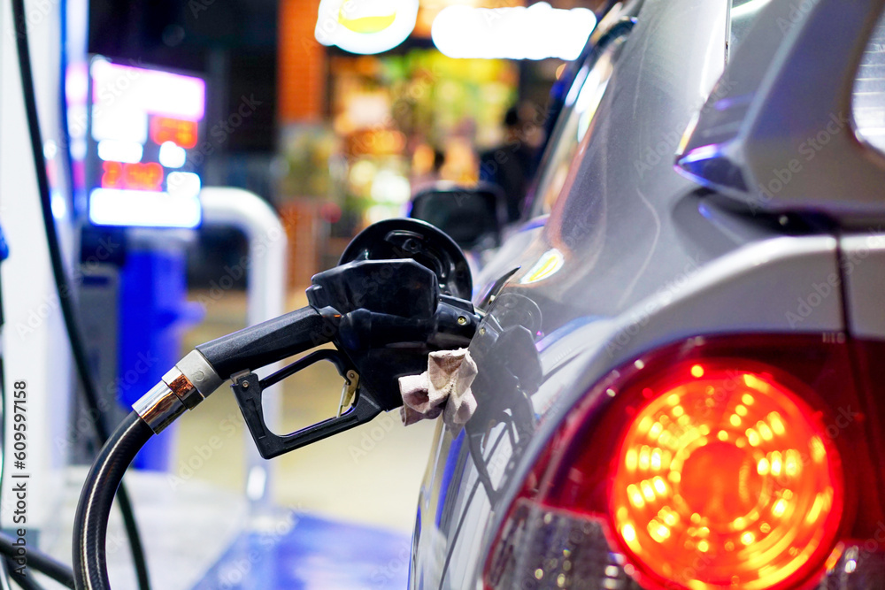 Car parked at gas station Refuel your car with gasoline or diesel with a fuel dispenser. Car parked at gas station Refuel your car with gasoline or diesel with a fuel dispenser.