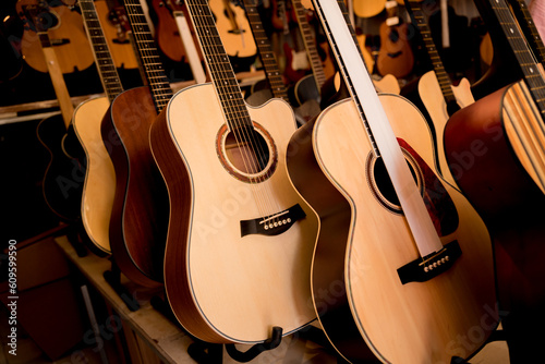 Many rows of classical guitars in the music shop
