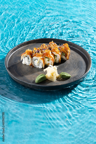 japanese cuisine sushi rolls on blue water background