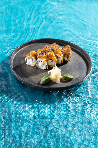 japanese cuisine sushi rolls on blue water background