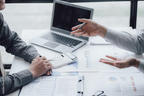 businessman working on desk office with using a calculator to calculate the numbers, finance accounting concept