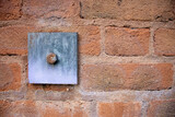 iron and steel retaining plate and bolt in a red brick wall