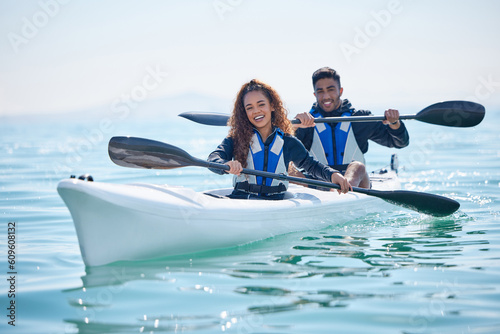 Kayak, rowing boat and couple on a lake, ocean or river for water sports and fitness challenge. Portrait of man and woman with a paddle and smile for adventure, teamwork exercise or travel in nature