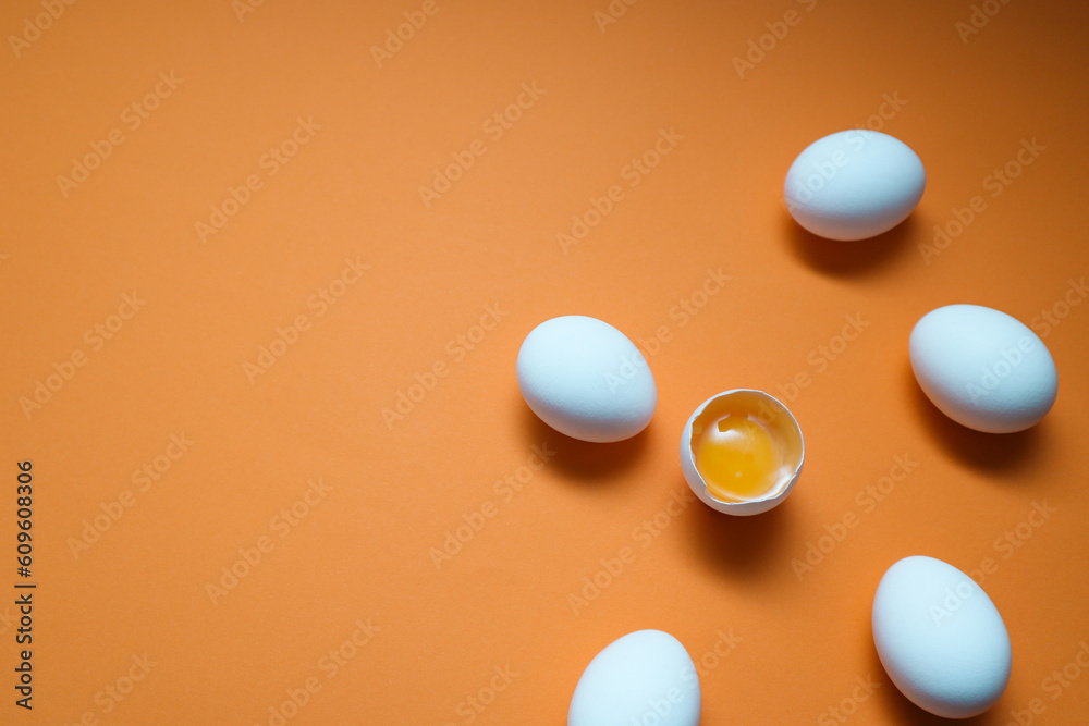 White eggs and egg yolk on the yellow background. White eggs and egg yolk on the yellow background.