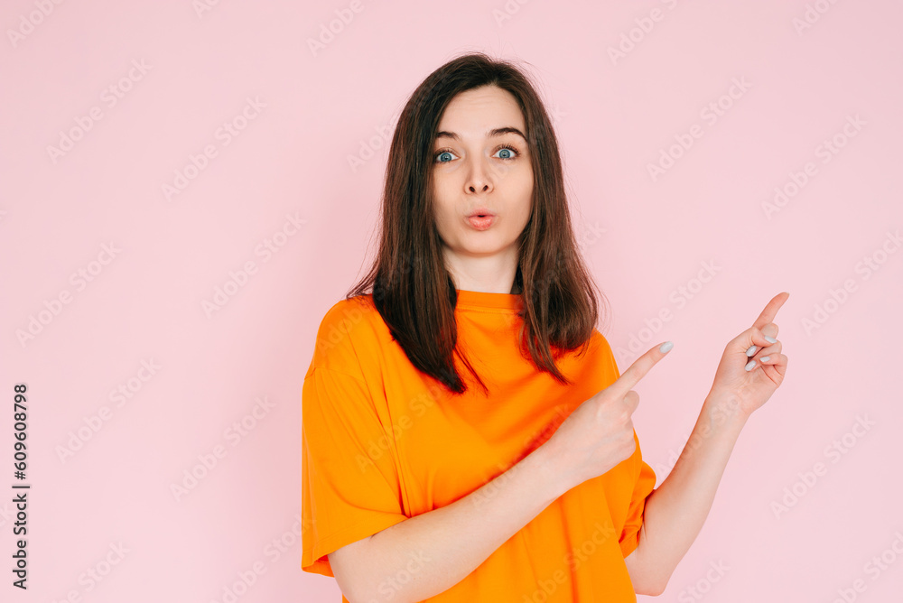 Engaging Playfulness: Humorous Woman Pointing Two Fingers at Empty Space - Interactive Concept with a Touch of Humor, Vibrant Pink Background. Engaging Playfulness: Humorous Woman Pointing Two Fingers at Empty Space - Interactive Concept with a Touch of Humor, Vibrant Pink Background.