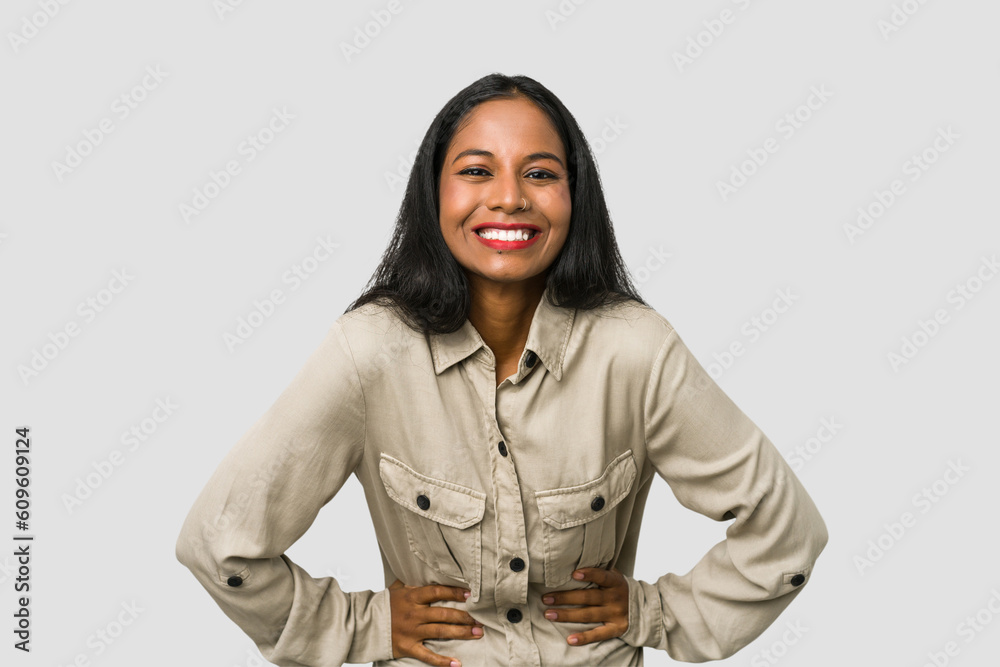 Young Indian woman cut out isolated on white background happy, smiling and cheerful. Young Indian woman cut out isolated on white background happy, smiling and cheerful.