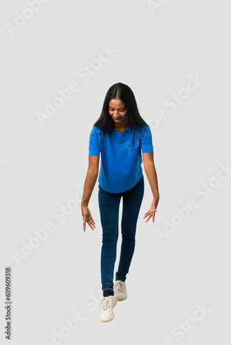 Young Indian woman standing isolated on white background