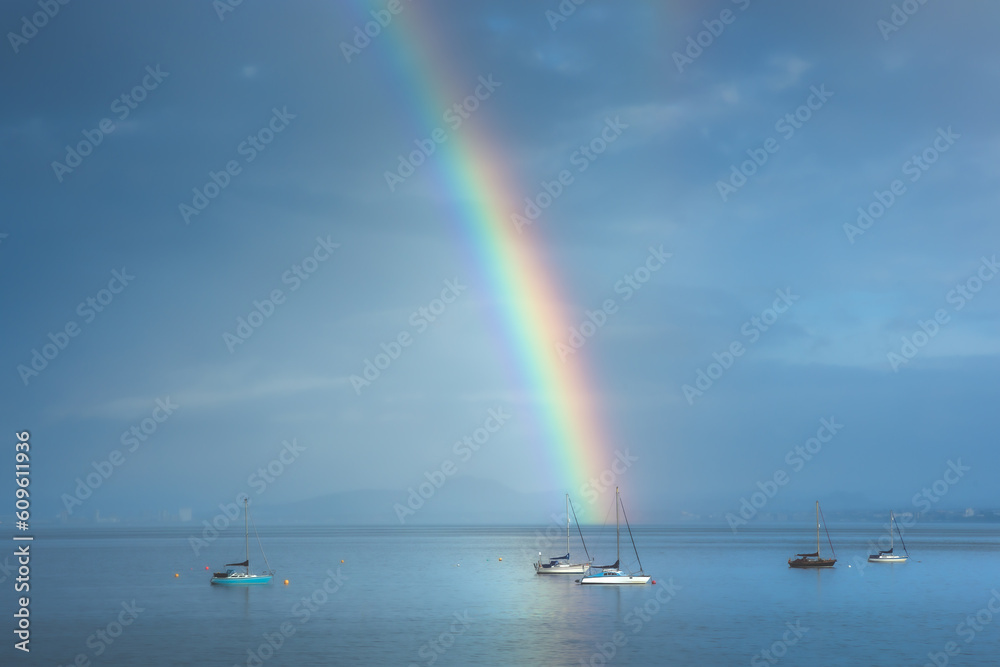 Beautiful rainbow in the sky arching over fishing boats and the Firth of Forth in the quaint village of Aberdour, Fife, Scotland, UK. Beautiful rainbow in the sky arching over fishing boats and the Firth of Forth in the quaint village of Aberdour, Fife, Scotland, UK.