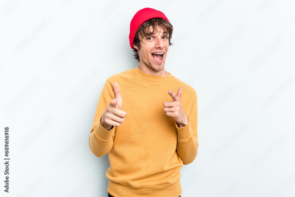 Young caucasian man isolated on blue background pointing to front with fingers. Young caucasian man isolated on blue background pointing to front with fingers.