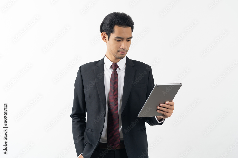 happy young asian businessman smiling and holding a touchpad in formal suit isolated on white background.