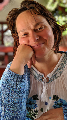 Cheerful Brown-Haired Woman Expressing Happiness in a Smiling Portrait