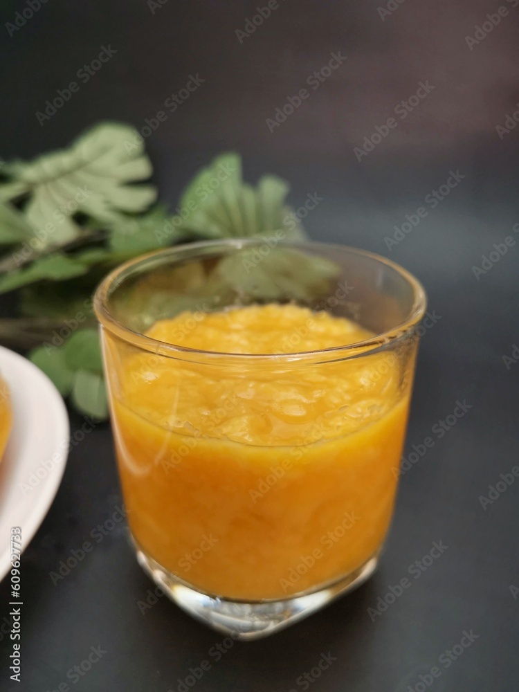 Mango smoothie on black background