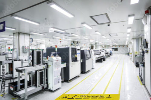 On a floor of the electronics manufacturing covered industrial linoleum pastes a yellow tape with a standard warning text: 