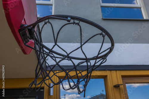 Beautiful view of basketball hoop with net in garden of house. Sweden.