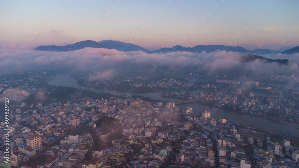 fog over the city at sunrise, cityscape nha trang city in vietnam shot from drone, gorgeous asia, beach by the sea, modern city in tropics