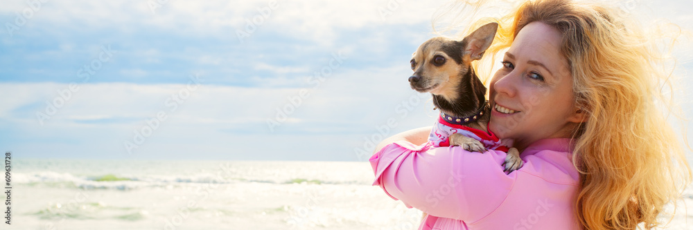 woman with a small dog on the background of the ocean sea, Vacation joy, traveling with a pet, tourism and leisure, banner, Fun and relaxation woman with a small dog on the background of the ocean sea, Vacation joy, traveling with a pet, tourism and leisure, banner, Fun and relaxation
