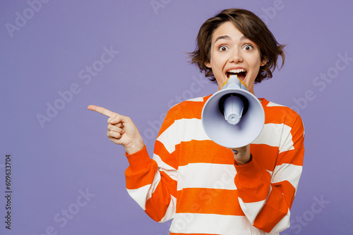 Young caucasian woman wear casual clothes sweatshirt hold in hand megaphone scream announces discounts sale Hurry up isolated on plain pastel light purple background studio portrait. Lifestyle concept